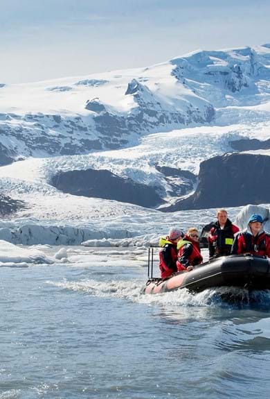 People sailing through the glacier lagoon of Vatnajokull