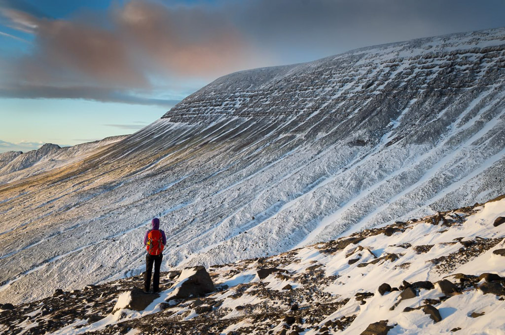 Hiker standing on Mount Esja in snowy conditions