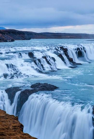 A big blue waterfall in The Icelandic nature 