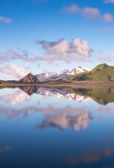 A reflection of mountains in a large still lake