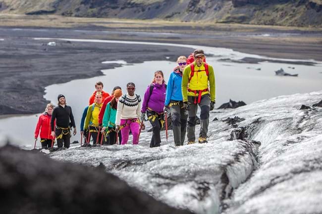 People hiking up Sólheimajökull on a glacier walk