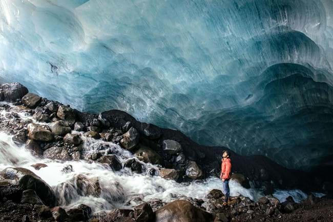 A glacier guide, exploring an ice cave on Virkisjökull
