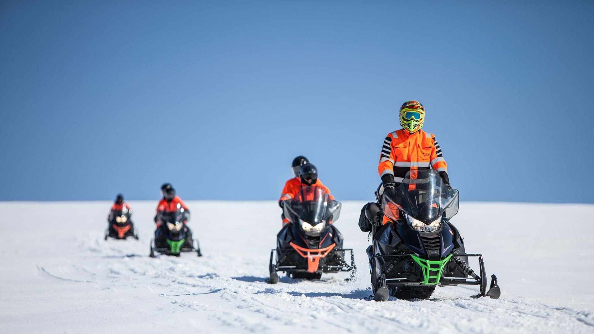 A group of people on Snow mobile tour with their Icelandic Mountain Guide 
